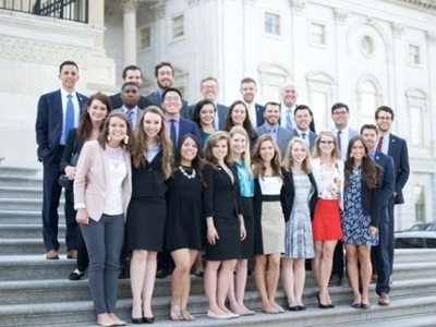 A group of students are standing in front of the nation's capital.