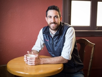 Doug Hewitt sitting at a table with coffee