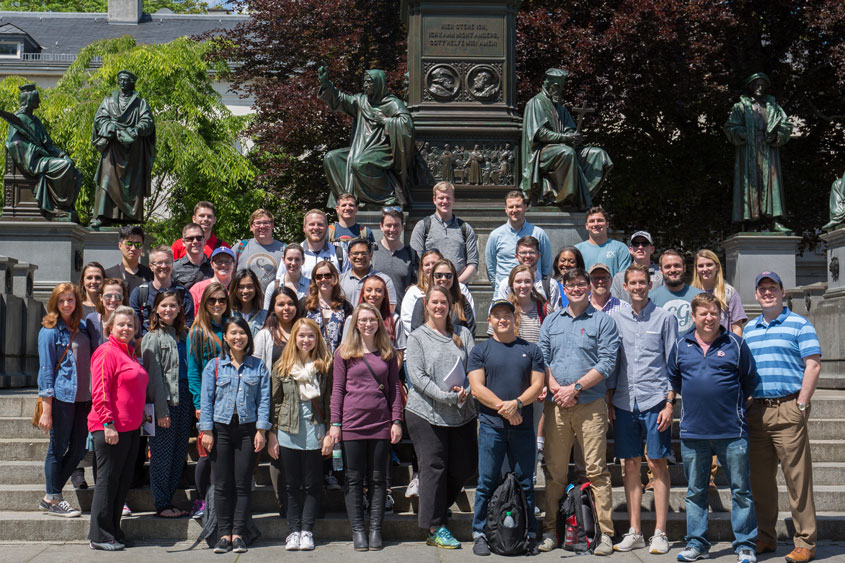 The class in front of Lutherdenkmal Statue depicting Luther and his greatest supporters