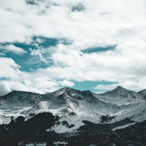 3. Pictures of dark grey/snowy mountains. The foreground is black, and the middle of the mountains is white. The clouds are covering the majority of the sky.