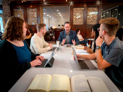 Dr. Mike Williams, professor of history, teaches students in a conference room
