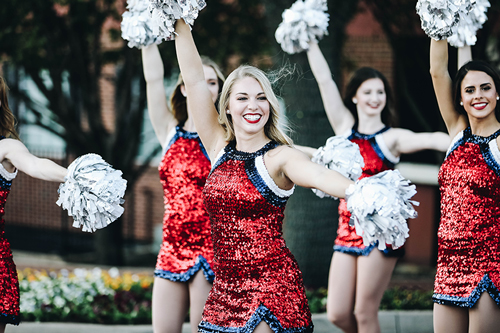 Group of dancers outside with red sparkling uniforms