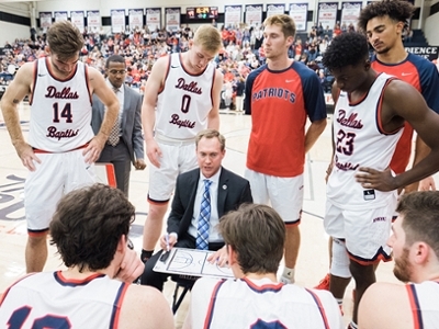 Coach Flickner walks his team through a play during a time-out