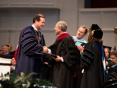 Dr. Jorge Juan Pastor shakes Dr. Adam Wright's hand as he receives his honorary doctorate degree