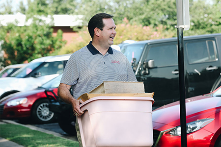 DBU President, Dr. Adam C. Wright, helps with moving in new DBU students - Fall 2018