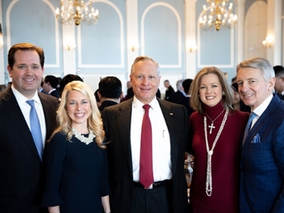 Dr. Adam Wright and his wife, Candice are standing with 2 men and a women. 