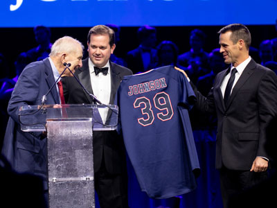 Dr. Adam Wright and Dan Heefner present Sam Johnson with DBU Baseball jersey