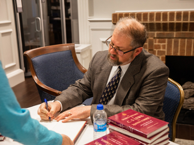 Dr. Mitchell signing his book
