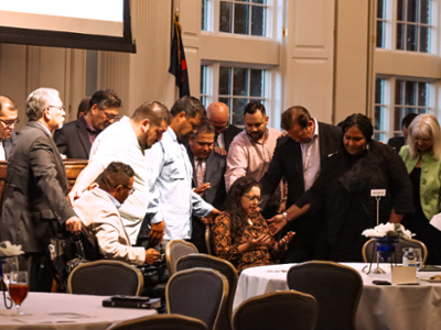 Group prays over Dr. Irene Gallegos