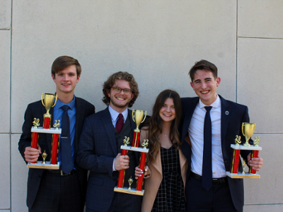 Debate Team holding trophies 