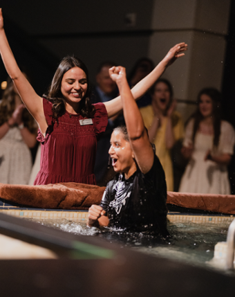 picture of Kathleen cheering as a woman gets baptized