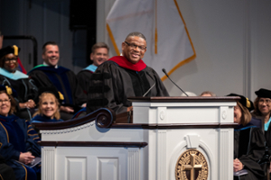 picture of Pastor Oscar standing behind a podium