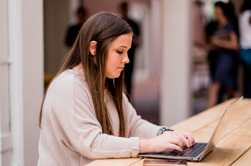 college student with laptop studying