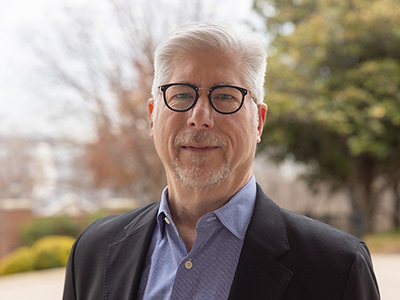 headshot of Kenneth Koester standing outside in Dallas