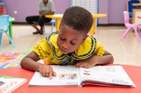 kid reading a book