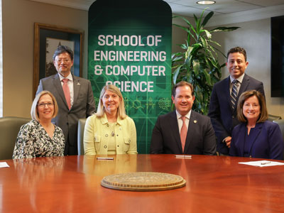 Officials from Baylor University and Dallas Baptist University signing the agreement on Baylor's campus in Waco