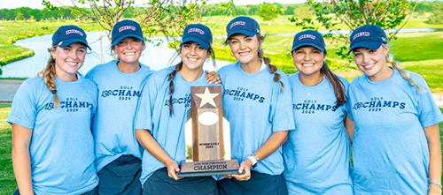 DBU's women's golf team standing with trophy