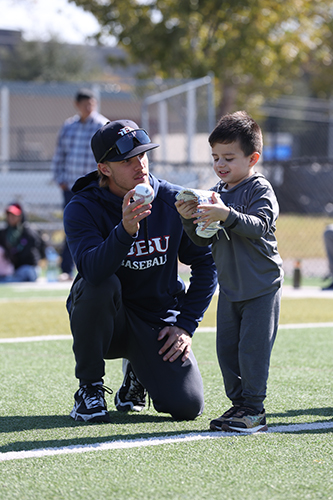 DBU baseball player with kid at Mercy Street 