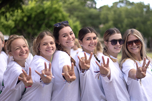 London Smith with a group of girls standing outside