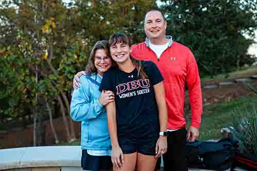 Sam Jones standing with her family at her baptism