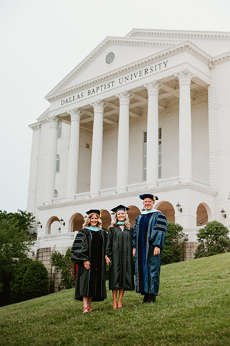 Dr. Gary Chevalier standing with his wife and daughter in front of the DBU chapel