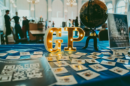 a Group Projjject event - close up of table with the letters GP and various pieces of paper