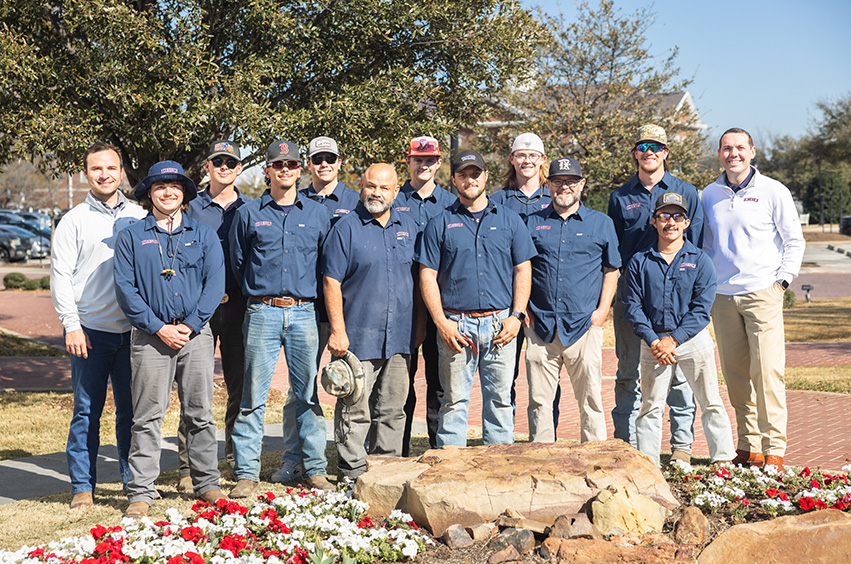 group photo of DBU's landscaping team standing outside in Dallas