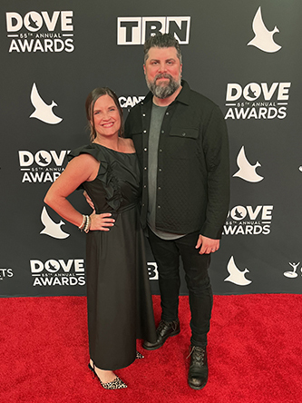 Chris Clayton with his wife on the red carpet at the Dove Awards