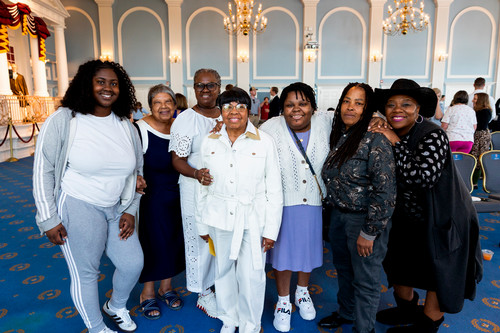Women smiling at a reception honoring Linda Smith.