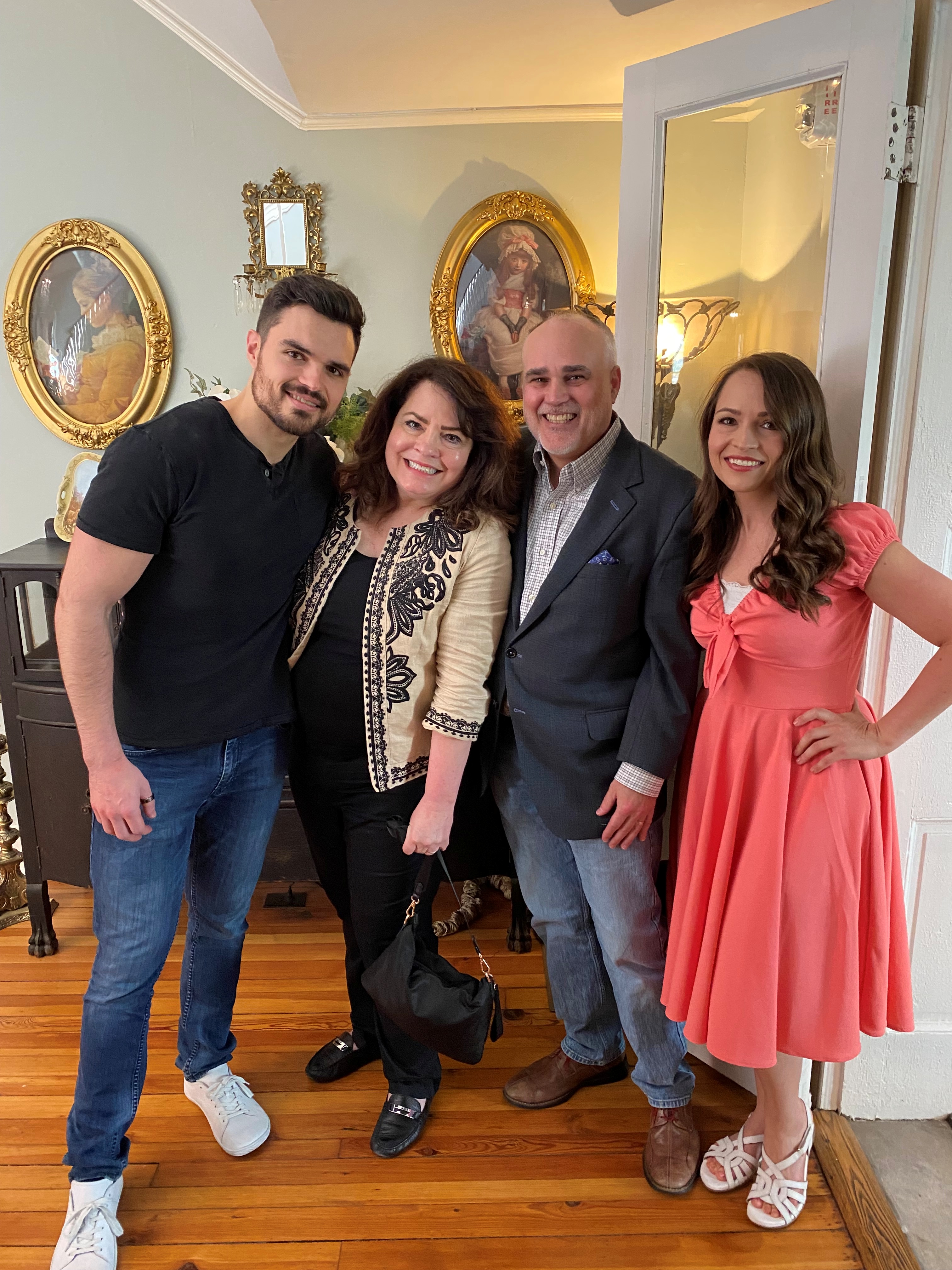 Ed Fry and family smiling in front of ornate framed artwork