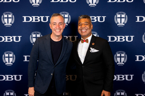 Will Guidara and Chris Holloway in front of a DBU backdrop