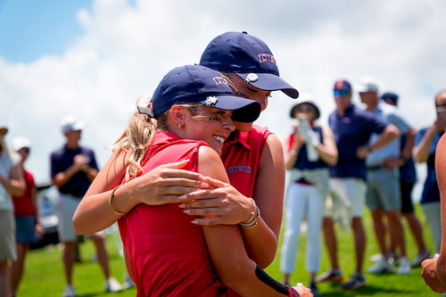 DBU golfers celebrate win with hug on course, crowd behind
