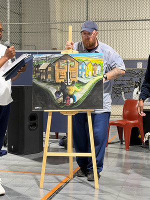 Man presents artwork on an easel during InterLIFT program