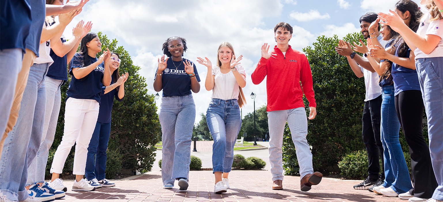 girl high fiving someone as she walks down the aisle