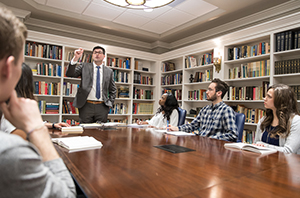 college students listening to a professor teach