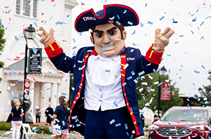 patriot man standing outside with confetti falling