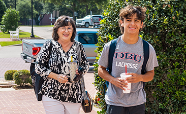 college student walking with his mom to new student orientation