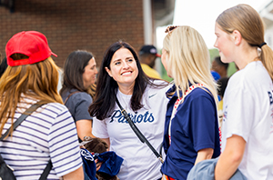 parents and students standing a DBU patriots baseball game