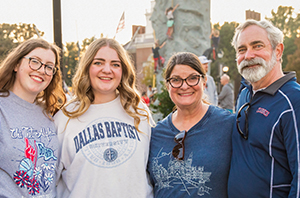 a dbu family standing together at homecoming