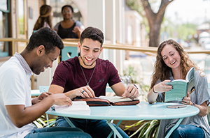 college students studying Scripture together outside