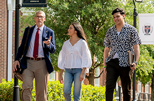 college students walking around a Christian campus with a professor