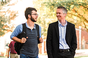 faculty member walking and talking to a college student at a Christian campus