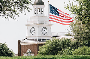 building replica of Independence Hall on a college campus with an American flag flying