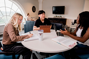 group of college students sitting around a table
