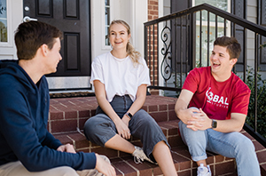 college students hanging out outside on a Christian campus