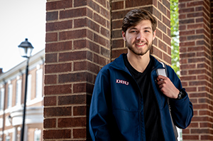 college student standing outside with backpack