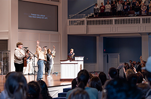 college students worshipping during chapel