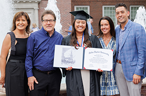 DBU graduate standing outside in a group photo with her family