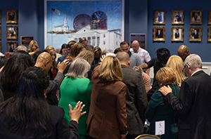 group of adults praying 