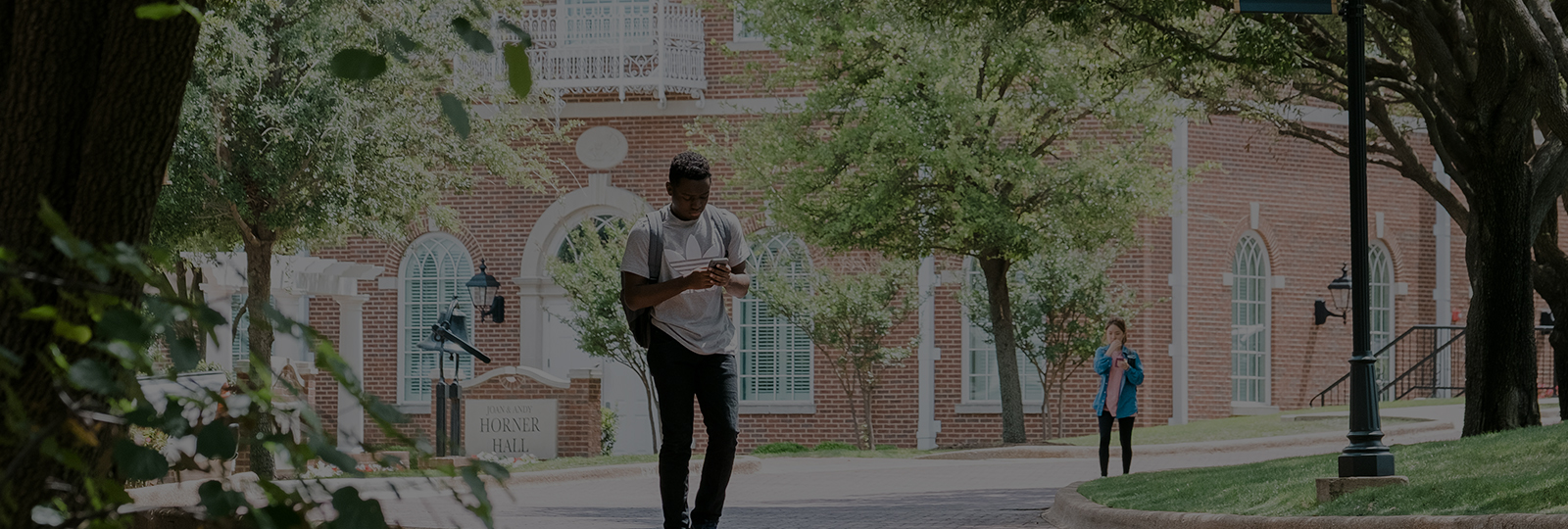 college student walking outside on a Christian college campus in Texas
